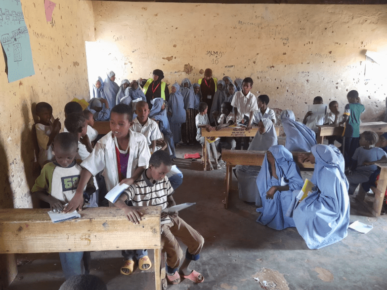 PARANET paralegal engaging students during a school visit on legal rights and documentation awareness in Wajir.